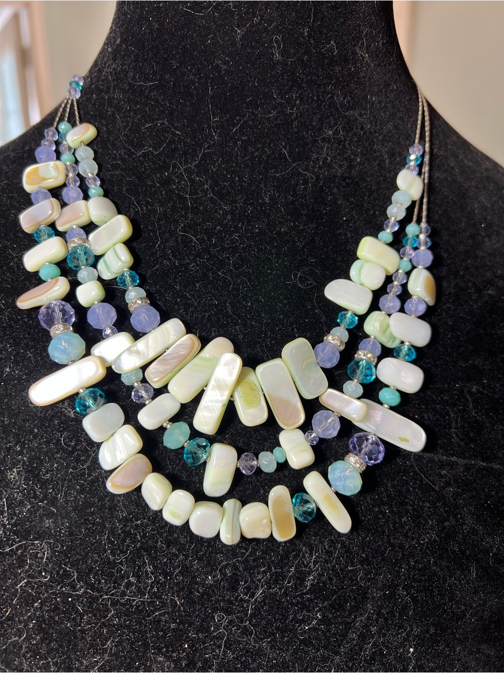 Three strand statement necklace with mother of pearl and blue, purple beads.